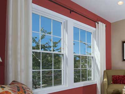 White-framed Harvey window along a red wall in a living room area